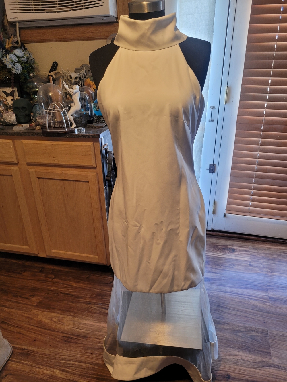 Sleeveless Cream High-Neck Mini Dress with Sheer Hem
